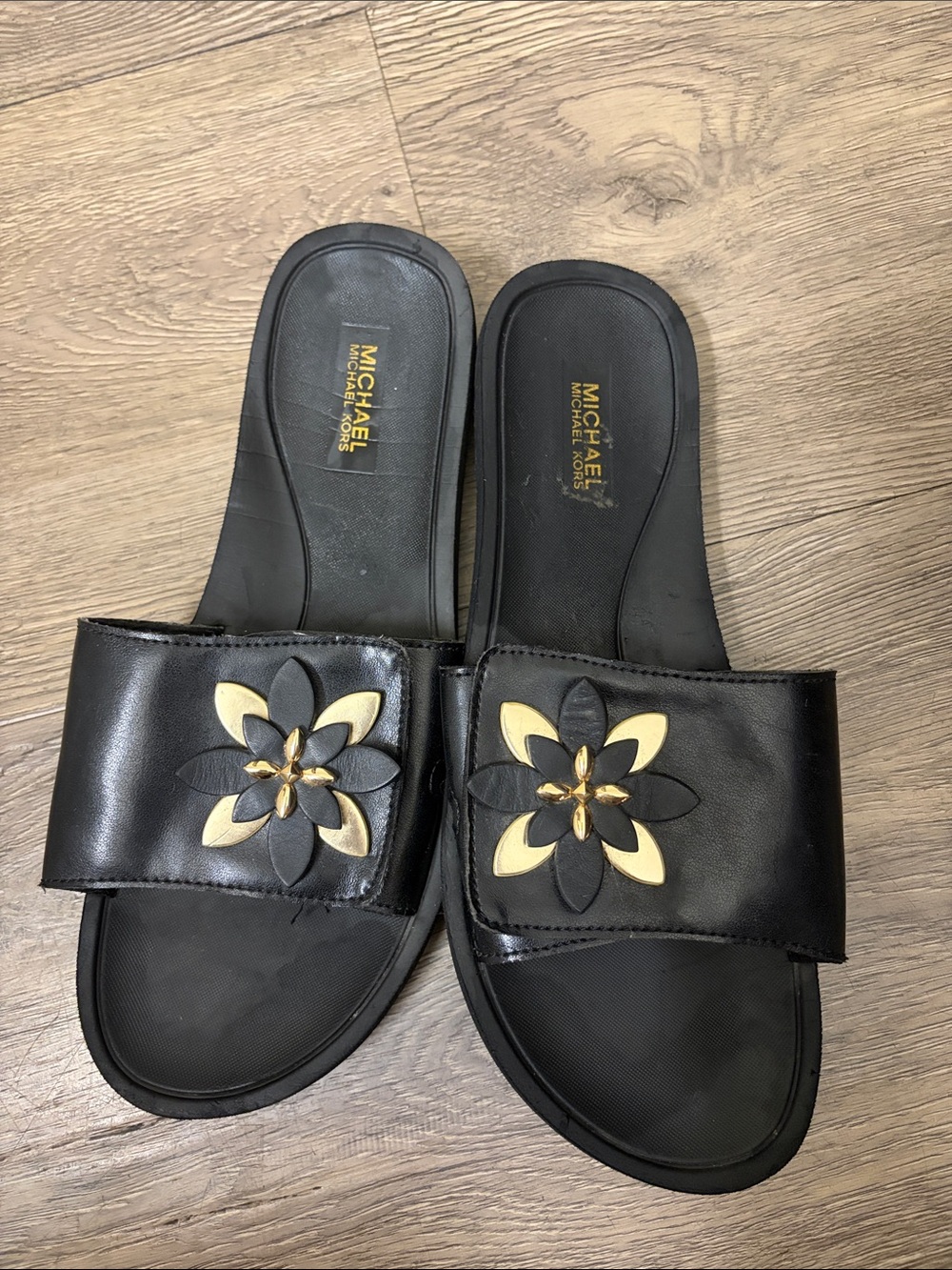 MICHAEL Michael Kors Black Slide Sandals with Gold Flower Detail